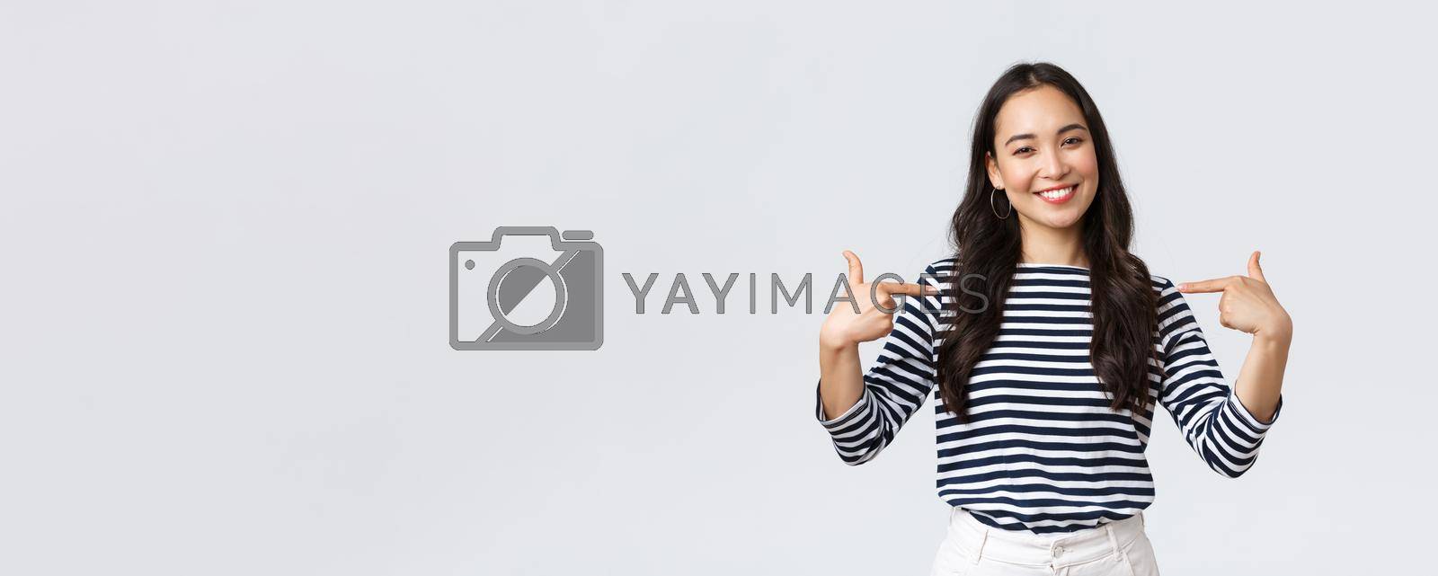 Royalty free image of Lifestyle, beauty and fashion, people emotions concept. Smiling friendly-looking woman ready to help, pointing herself with pleasant look, bragging own accomplishments, whtie background by Benzoix