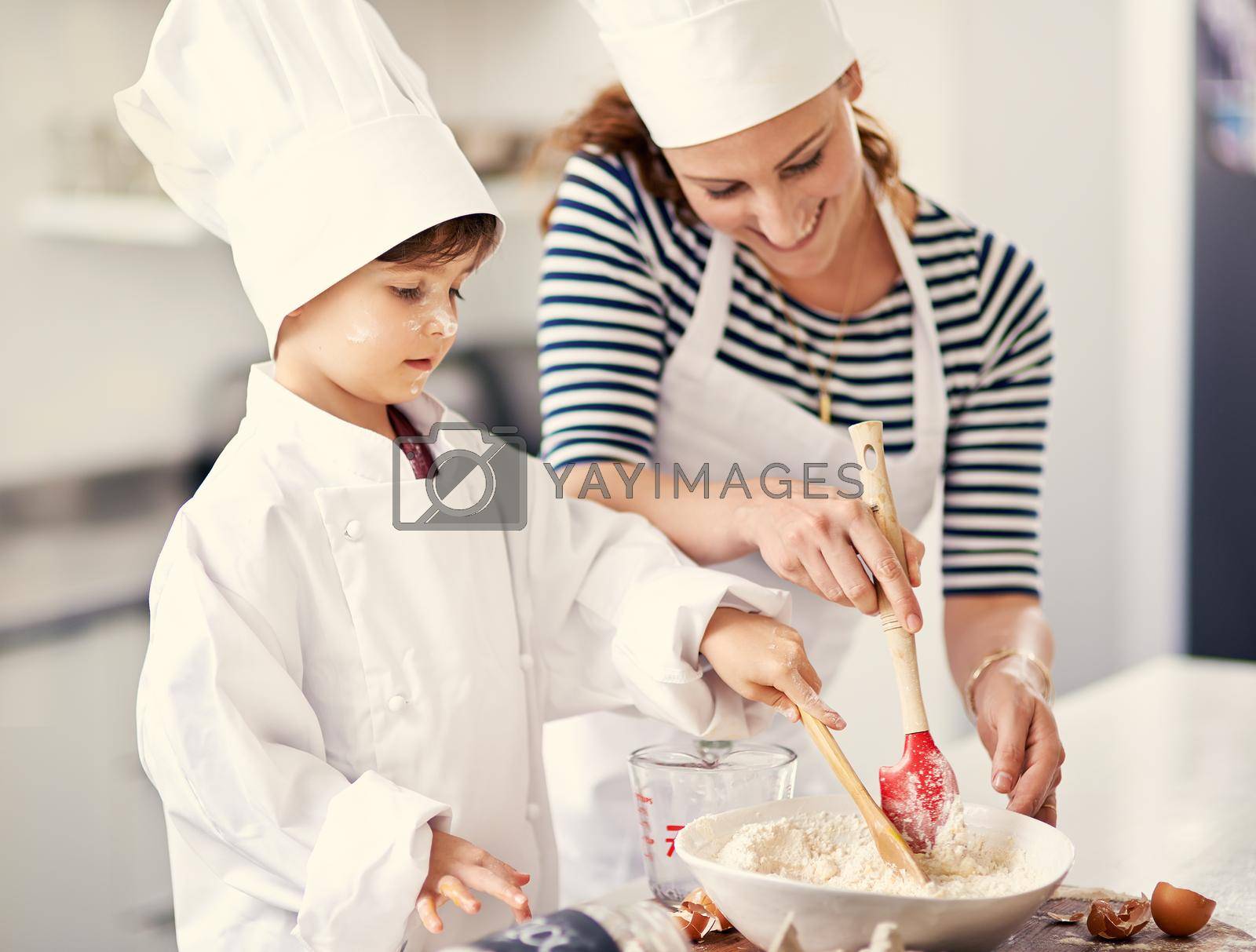 Shot of a mother and her son baking in the kitchen.