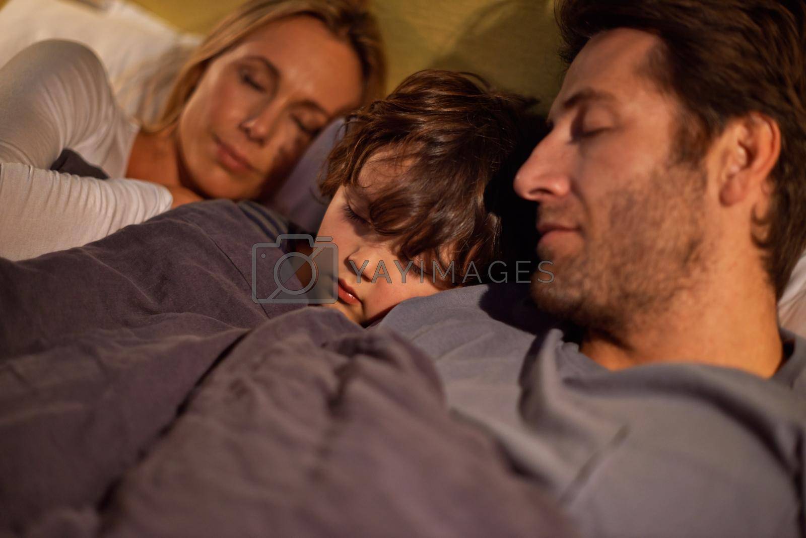 Shot of a young family sleeping beside each other.