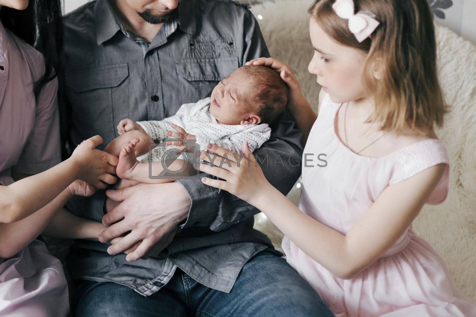 happy family looking at a newborn yawning baby. concept of family happiness.