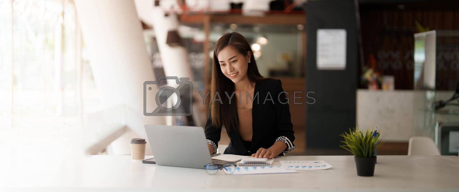 Portrait asian business woman working on laptop computer and calculator for financial. business accounting concept.