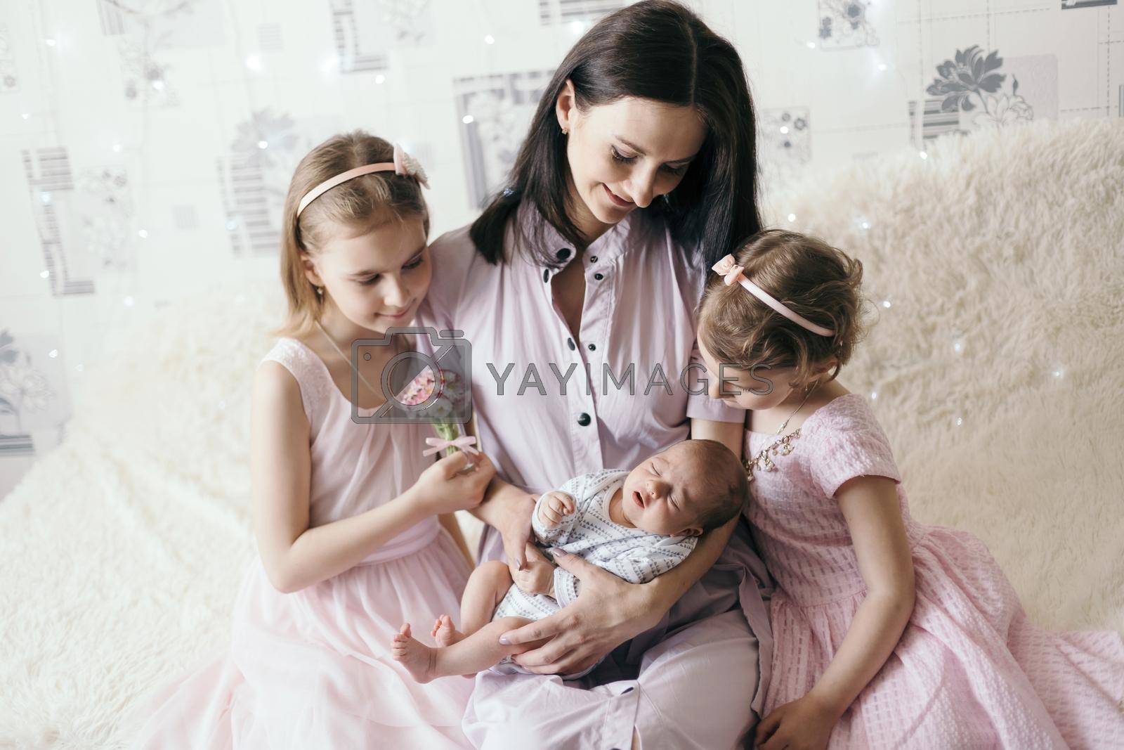 portrait of a happy mother with two daughters and a newborn son. concept of family happiness.
