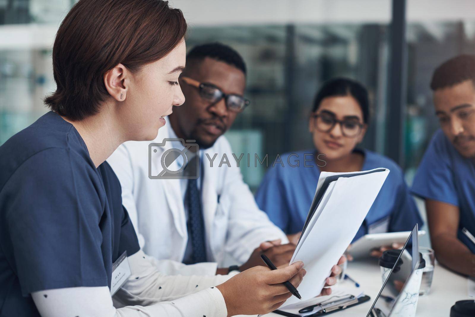 Royalty free image of Implement those changes and we can see. Shot of a group of nurses and doctors having a meeting together. by YuriArcurs