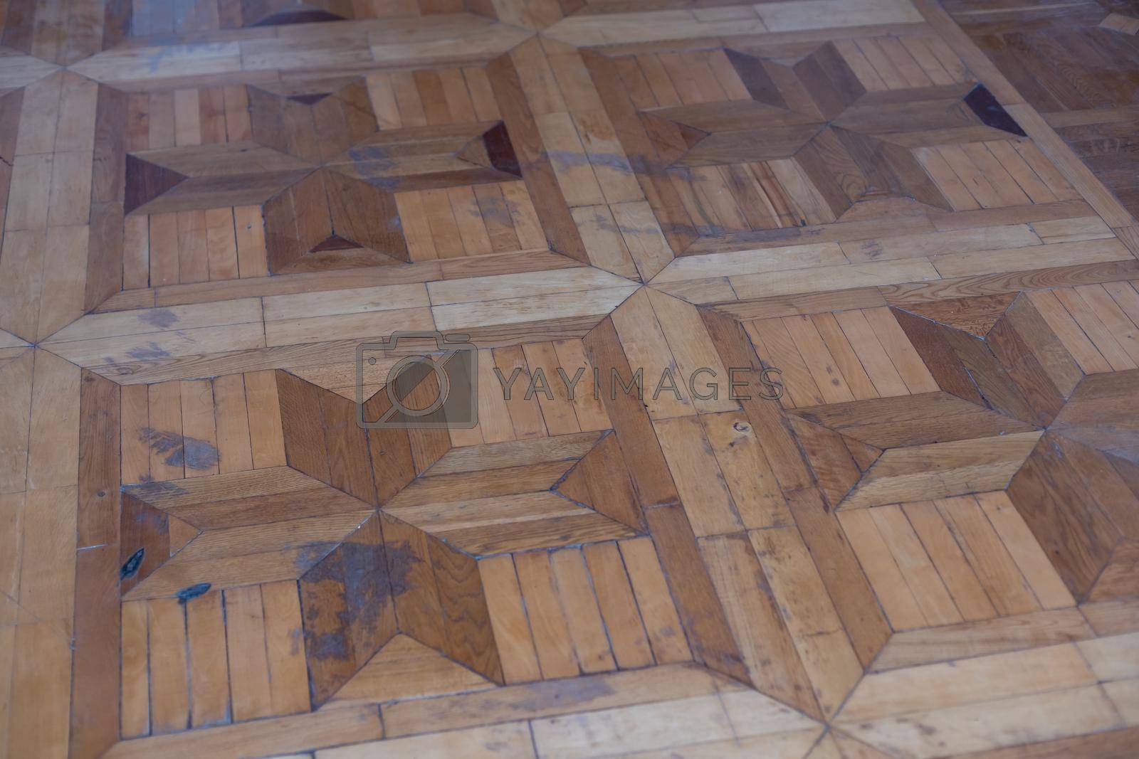 Texture of old worn parquet floor, close up.