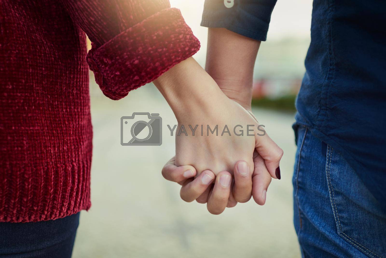 Royalty free image of True love means never letting go. Cropped shot of a couple holding hands outdoors. by YuriArcurs