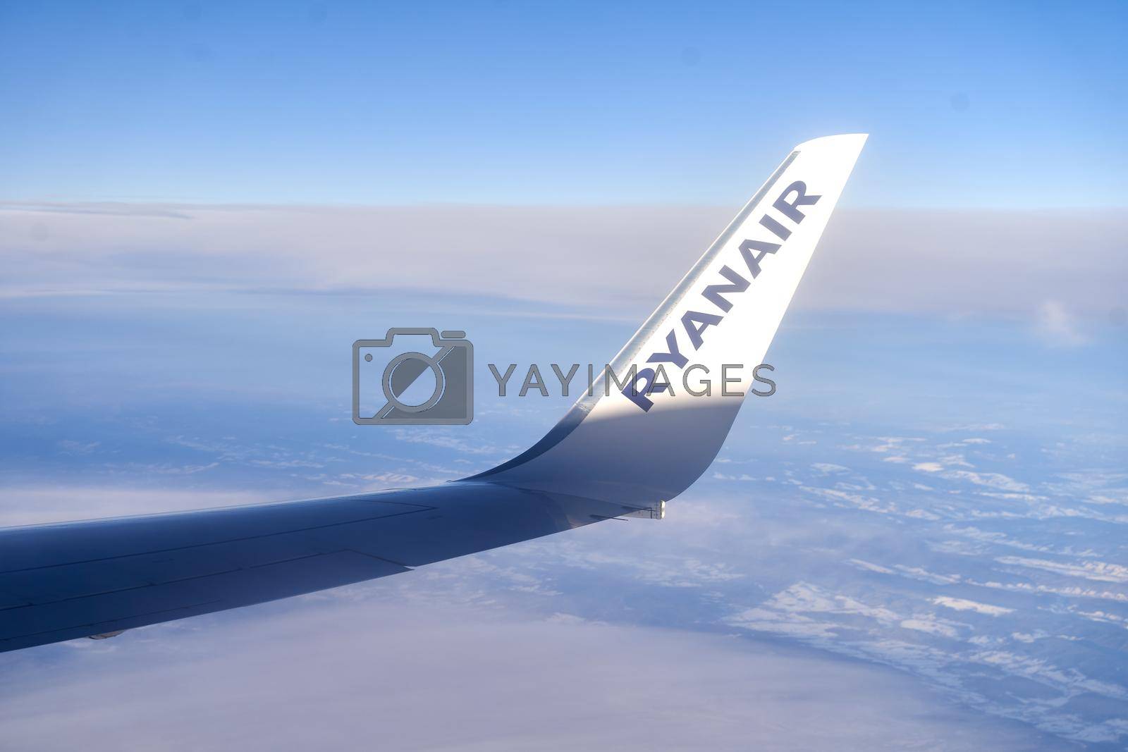 Pisa, Italy, Dec 4, 2021: Logo of Ryanair DAC, an Irish ultra-low-cost carrier, on the winglet of an airplane flying over Europe.