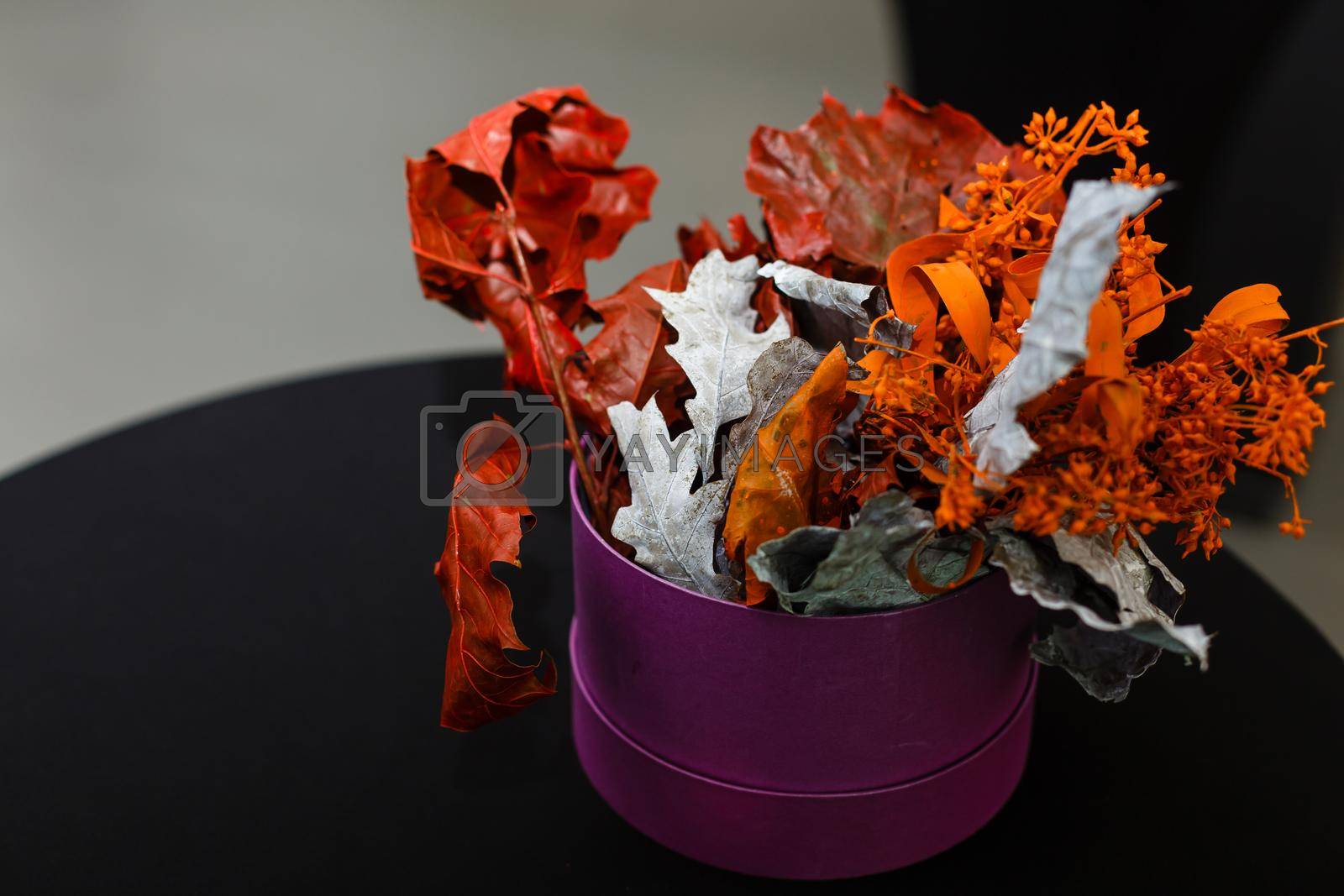 Royalty free image of A flower sits in a piece of cake on a table by Andelov13