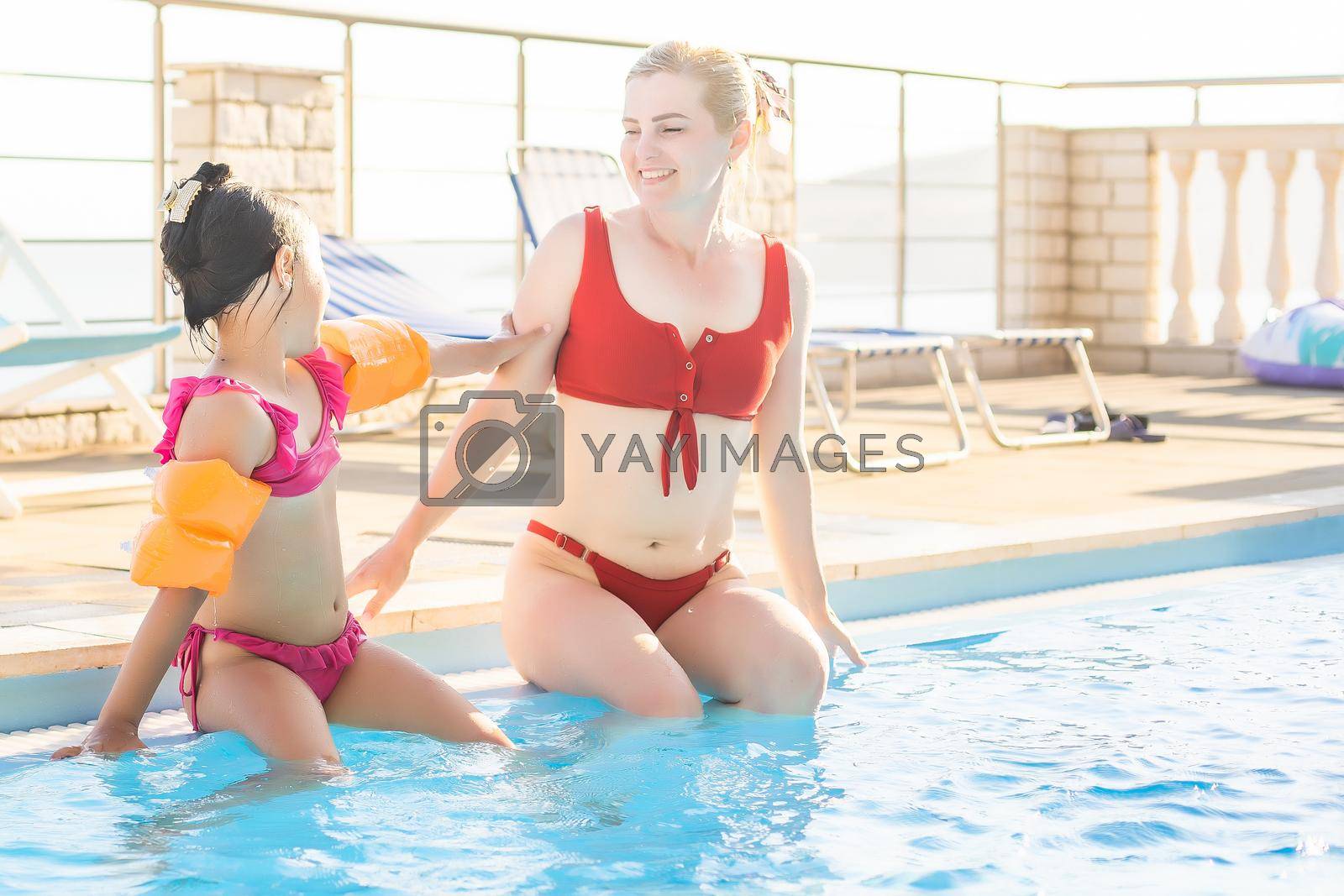 Happy mother and daughter in the swimming pool at the leisure center.