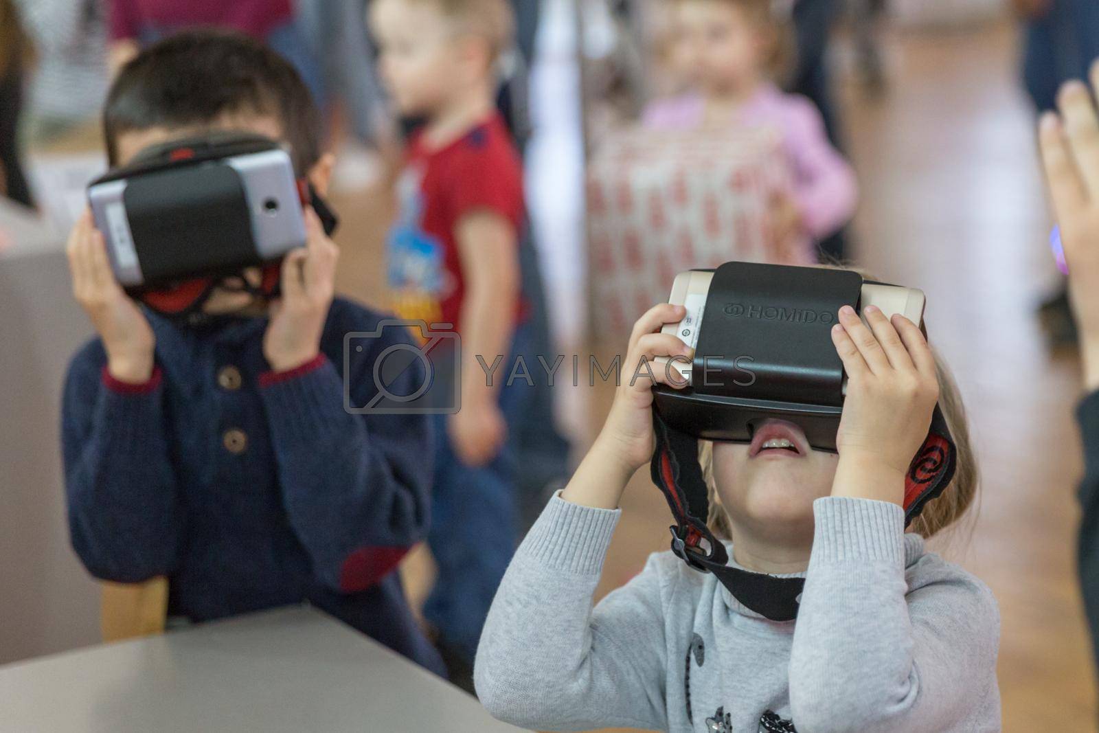 STAVROPOL, RUSSIA - APRIL 6, 2019 - Children having fun with virtual reality headsets in modern robot museum