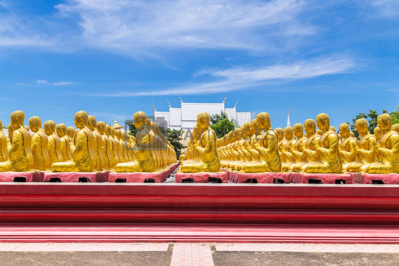 Royalty free image of Row of disciple statues surrounding big buddha statue in public to the general public worship worship, Thailand. by Gamjai