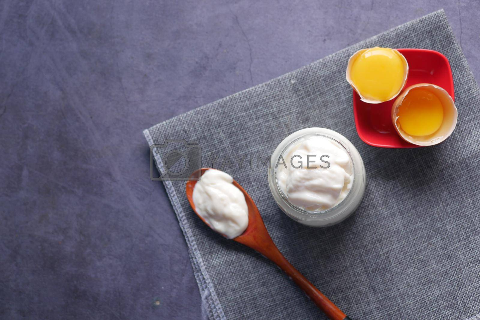 Royalty free image of Mayonnaise in container , oil and eggs on table by towfiq007
