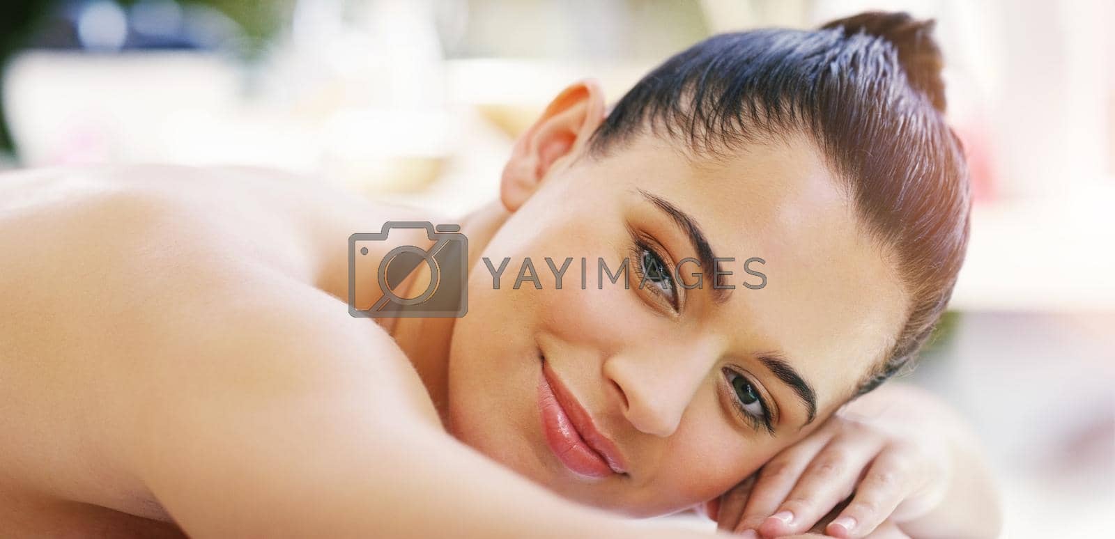 Royalty free image of I found my place of bliss. Shot of a young woman relaxing on a massage bed at a spa. by YuriArcurs