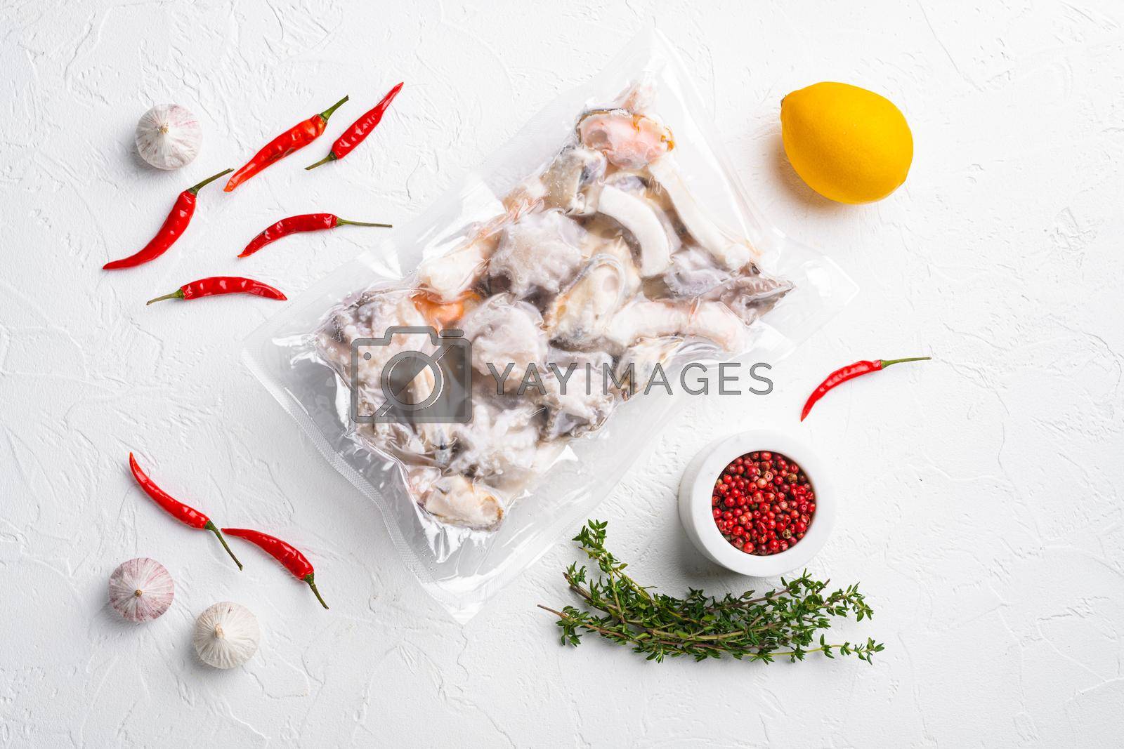 Royalty free image of Frozen seafood pack, on white stone table background, top view flat lay by Ilianesolenyi