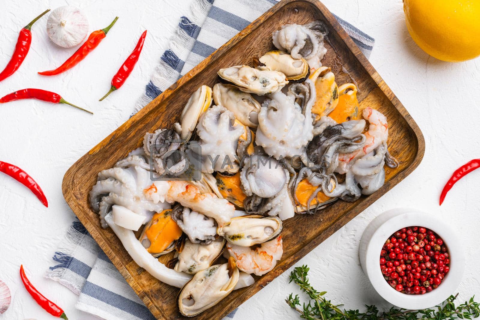 Royalty free image of Seafood board with shrimp, squid mussel and octopus, on white stone table background, top view flat lay by Ilianesolenyi