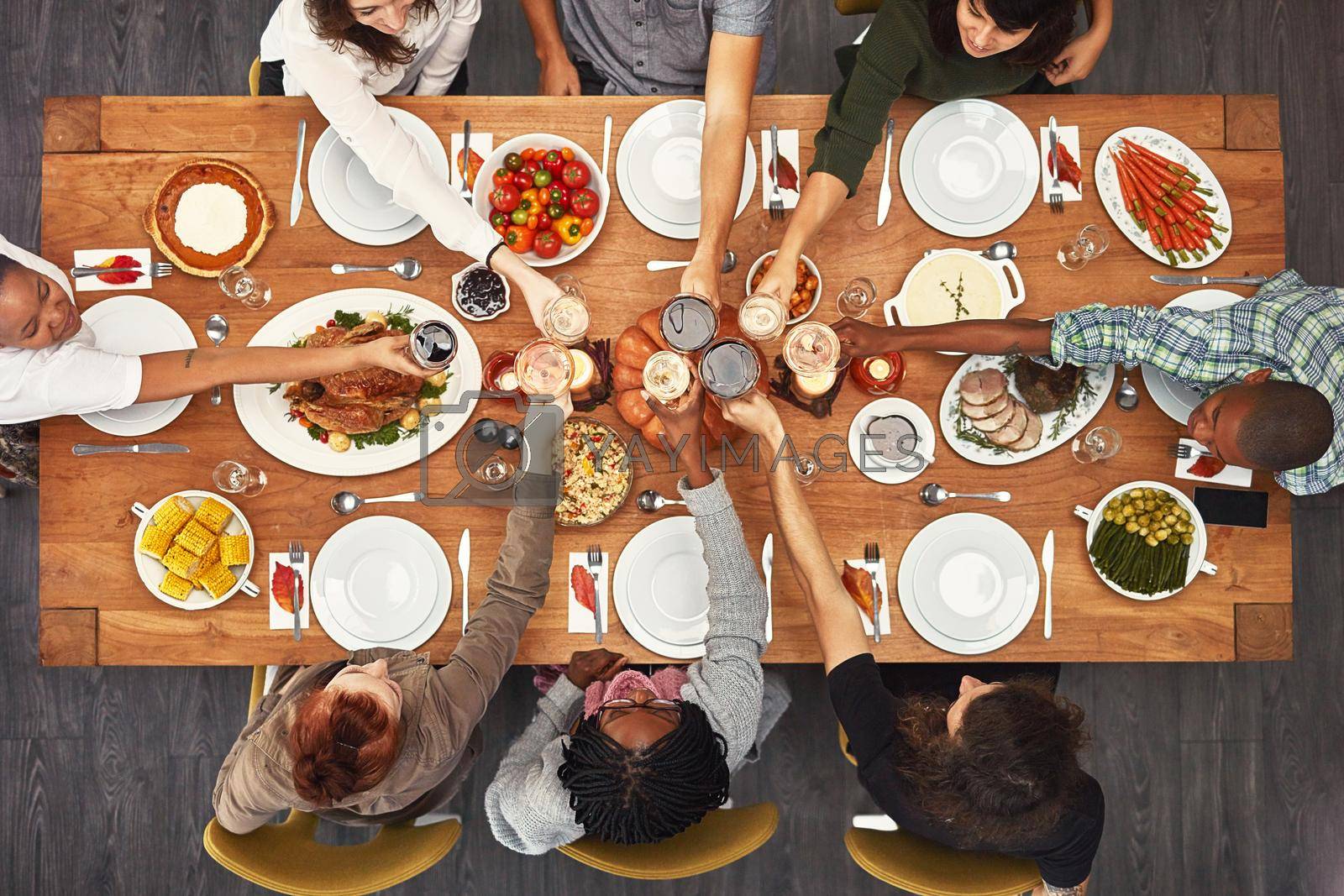 Shot of a group of people sitting together at a dining table ready to eat.