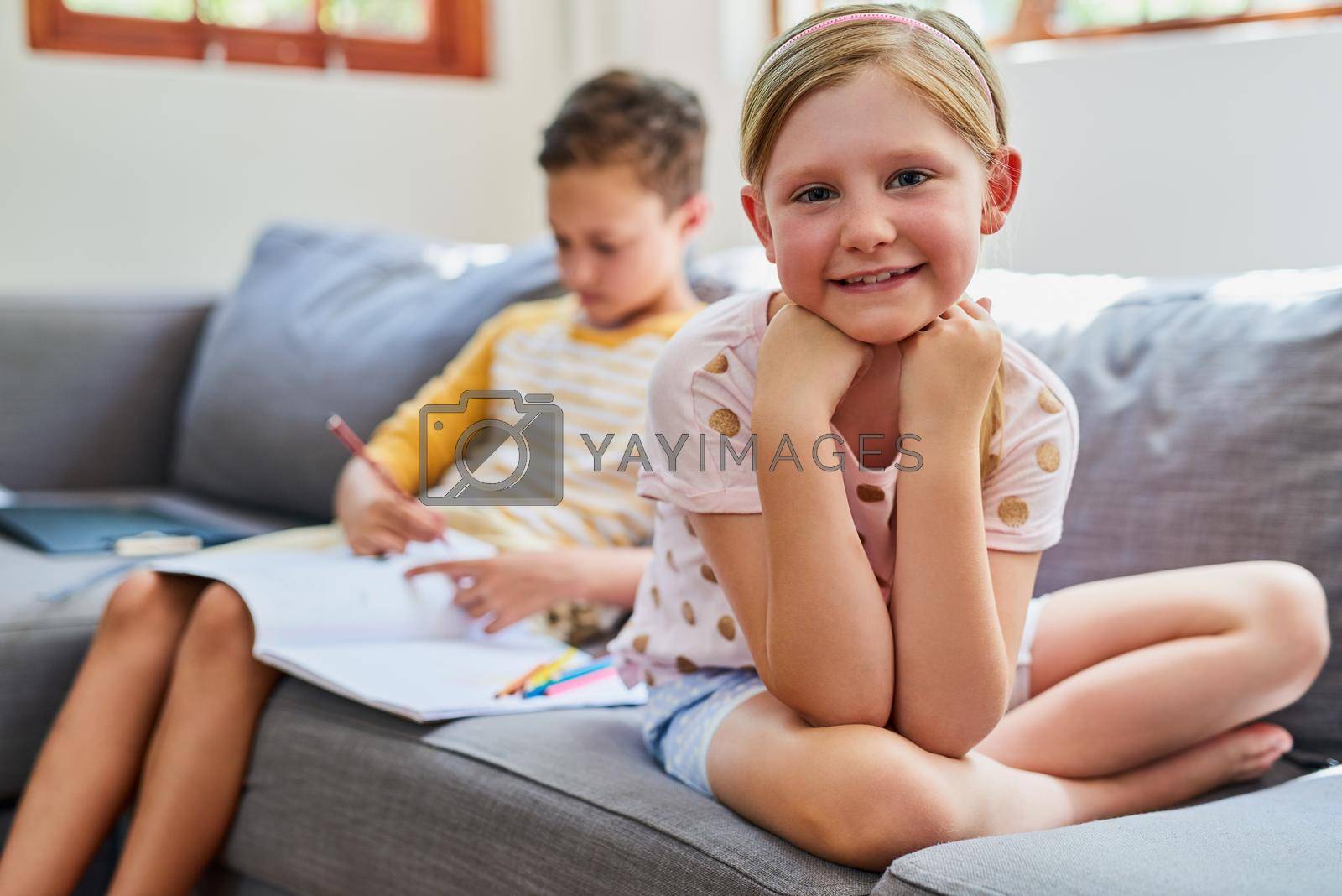 Royalty free image of My time to chill, my brother has homework to do. Cropped shot an adorable brother and sister doing schoolwork on the sofa at home. by YuriArcurs