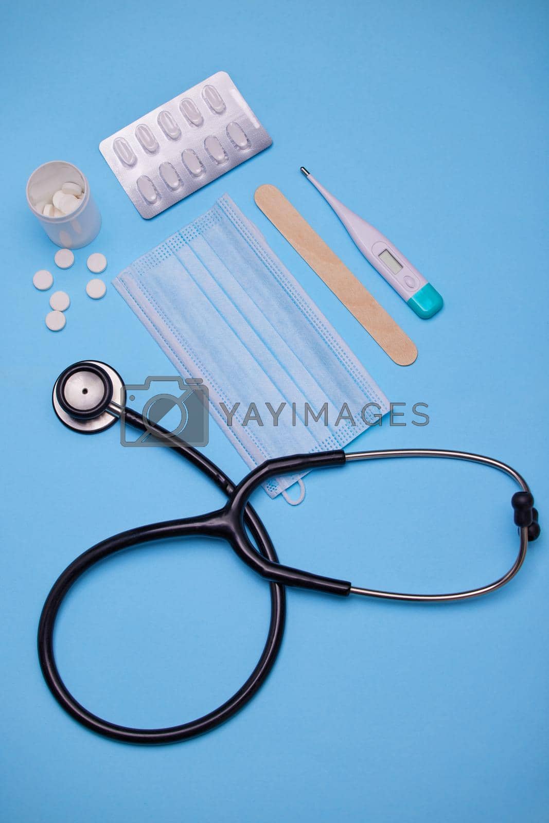 Royalty free image of See a doctor if youre feeling unwell. Studio shot of medical equipment against a blue background. by YuriArcurs