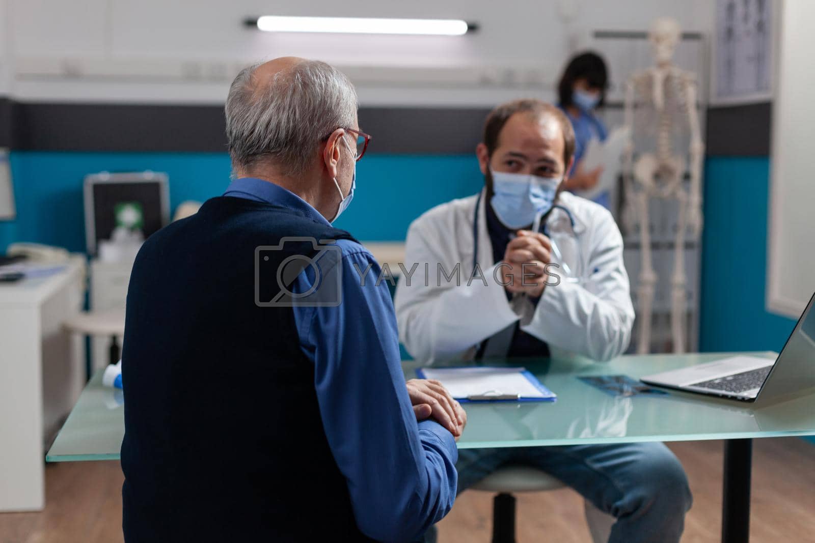 Royalty free image of Senior man meeting with general practitioner at checkup visit by DCStudio