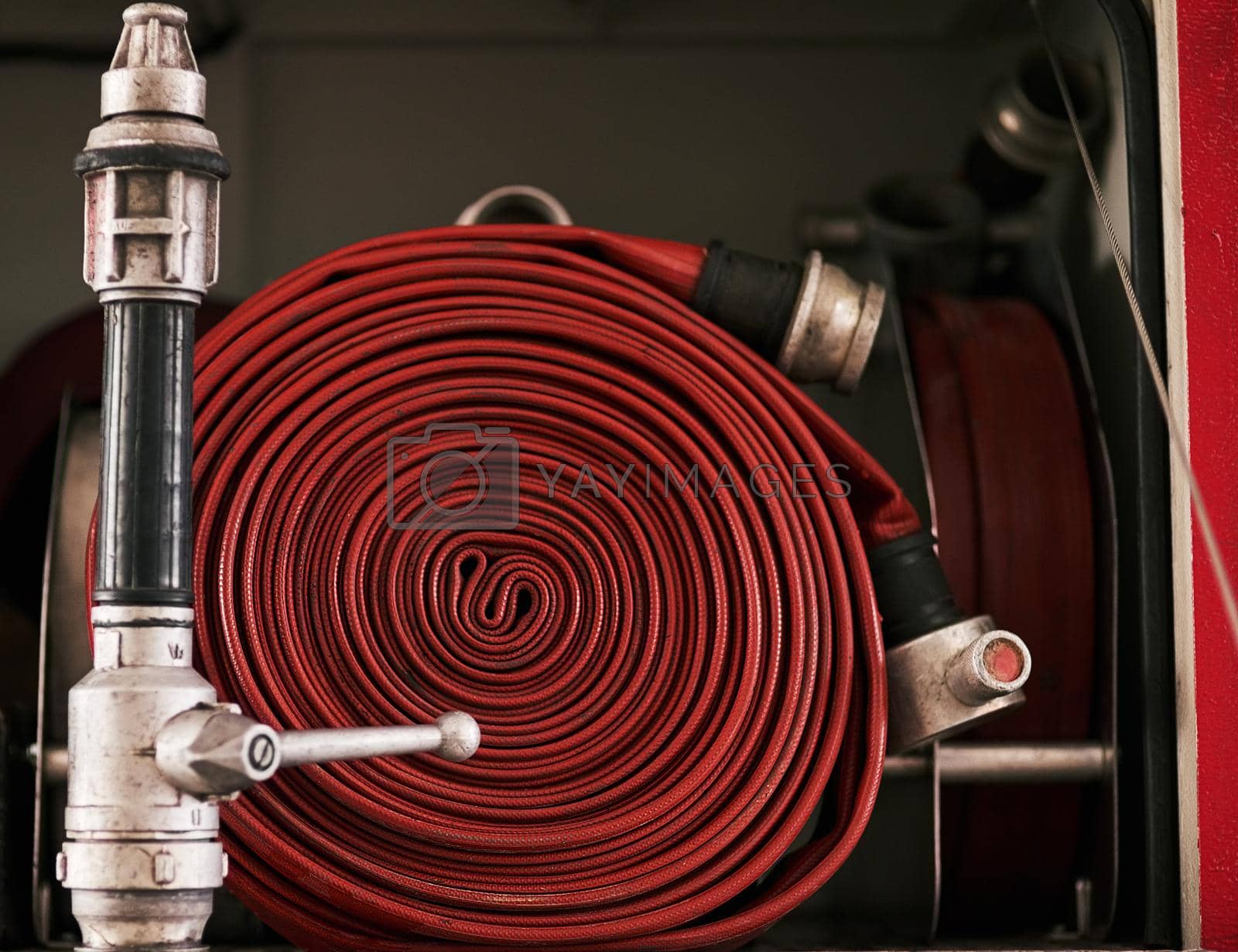 Royalty free image of Behind the scenes at the fire station. Cropped shot of a coiled fire hose. by YuriArcurs