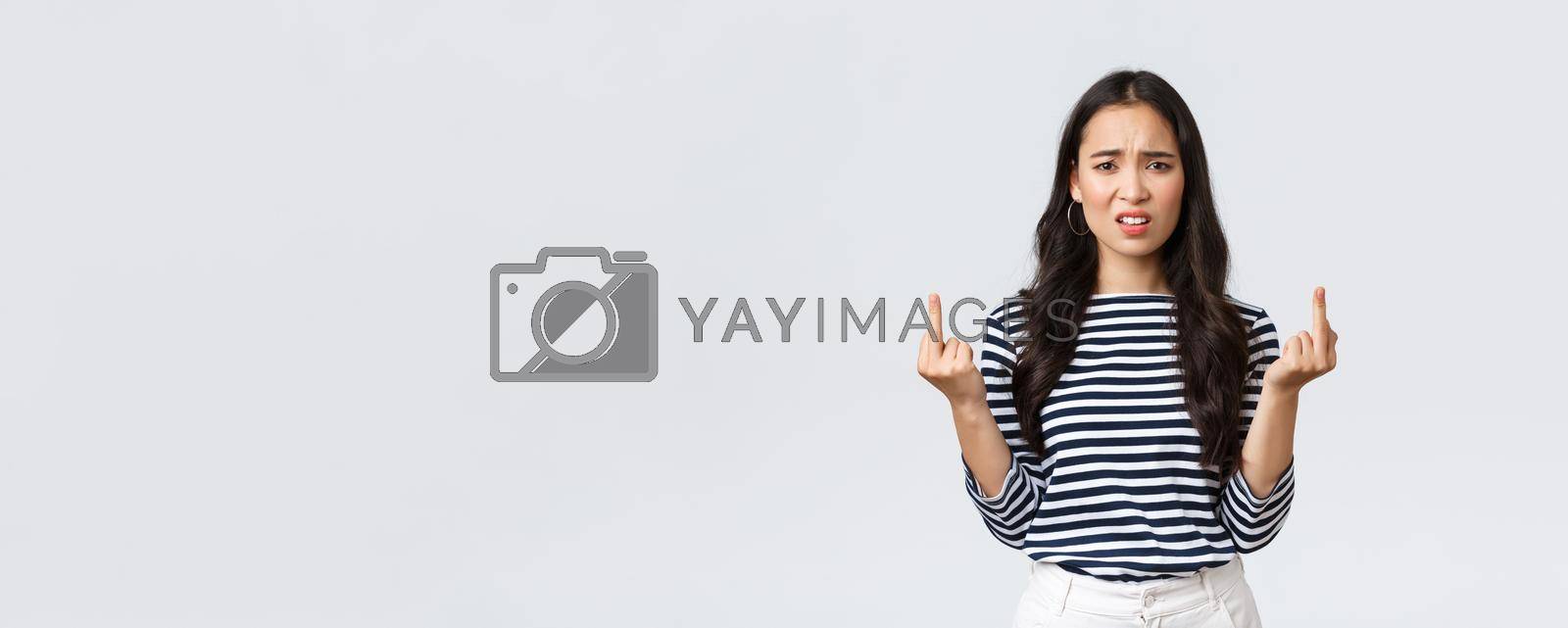 Lifestyle, beauty and fashion, people emotions concept. Annoyed pissed-off asian woman stare bothered and displeased, showing middle-fingers careless what people say, white background.