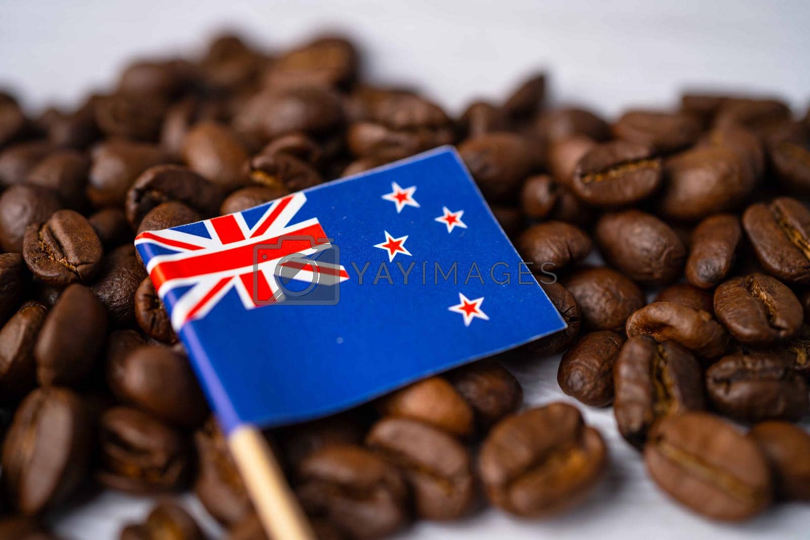 New Zealand flag on coffee beans; import export drink food concept.