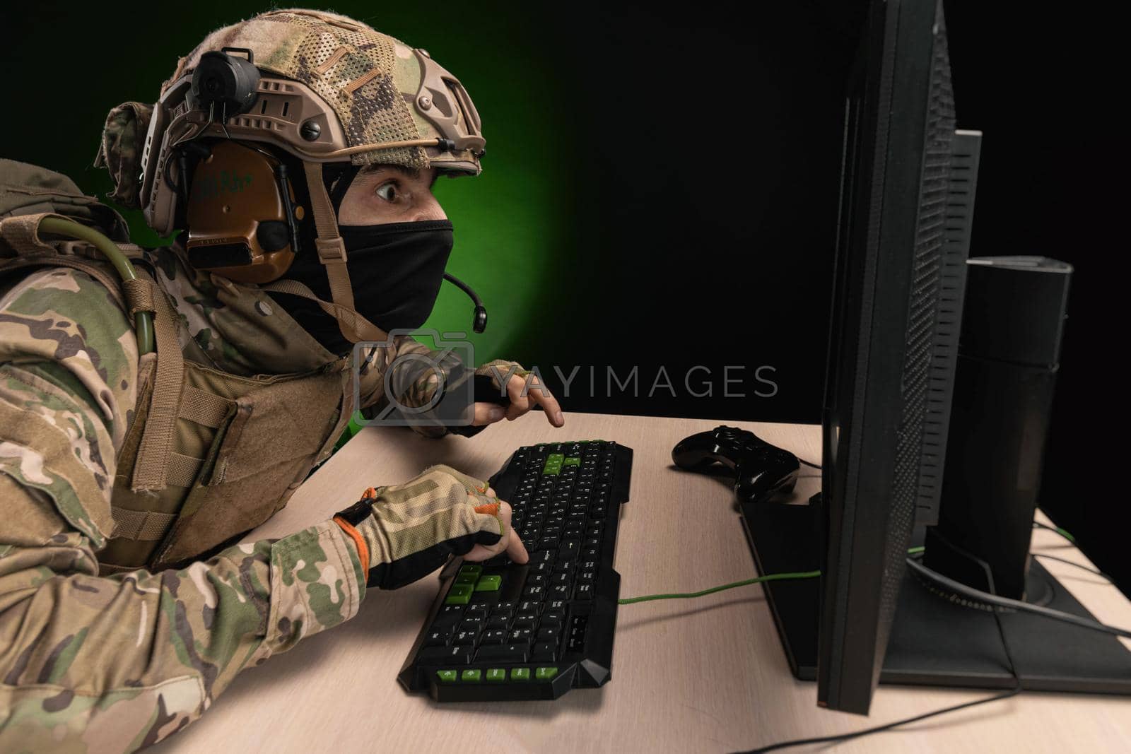 Royalty free image of a military soldier at a computer is conducting a cyber war by Rotozey