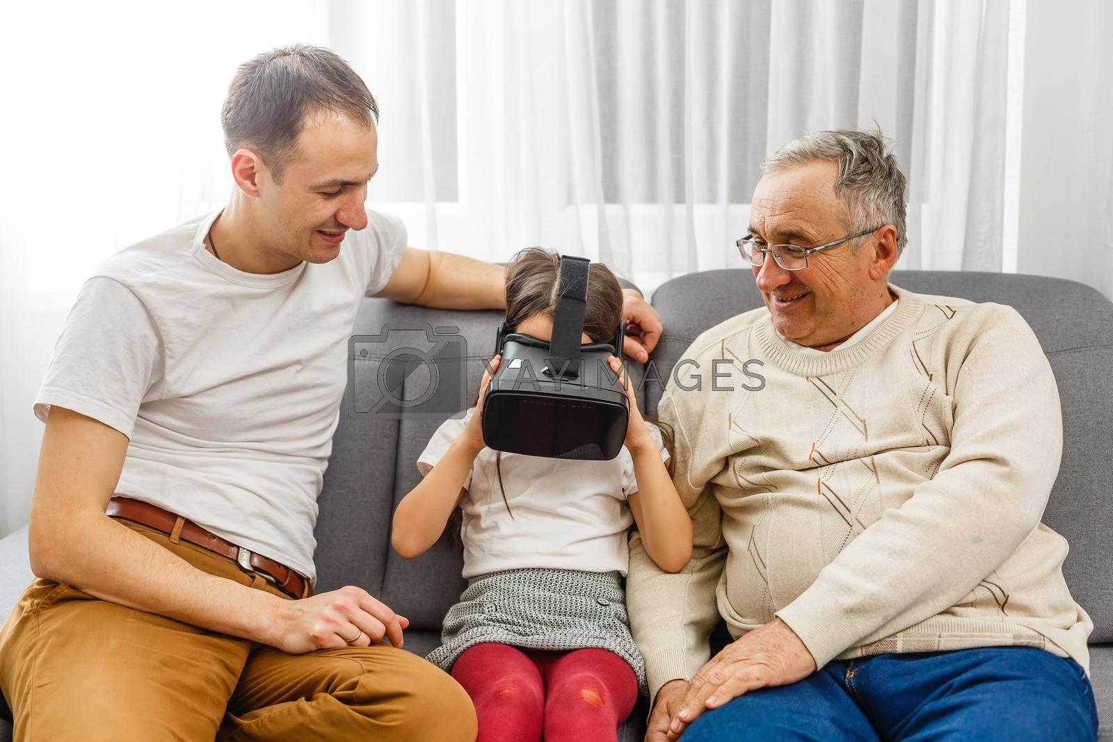 Royalty free image of grandfather and granddaughter with virtual glasses by Andelov13