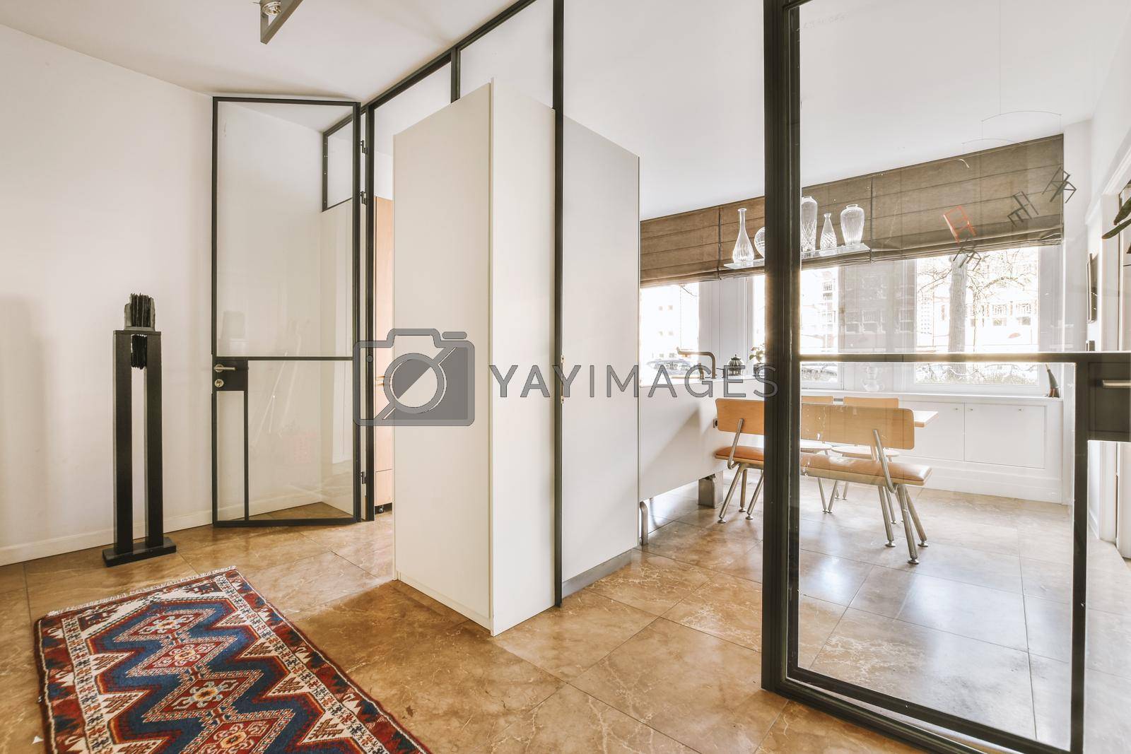 Royalty free image of A corridor leading inside the apartment with glass doors and walls by casamedia