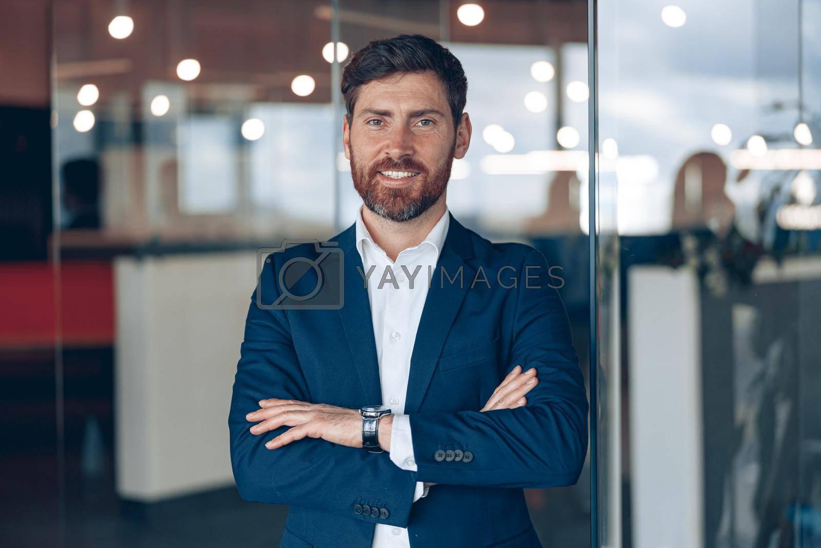 Portrait of a businessman while working in a modern office. Business and success concept