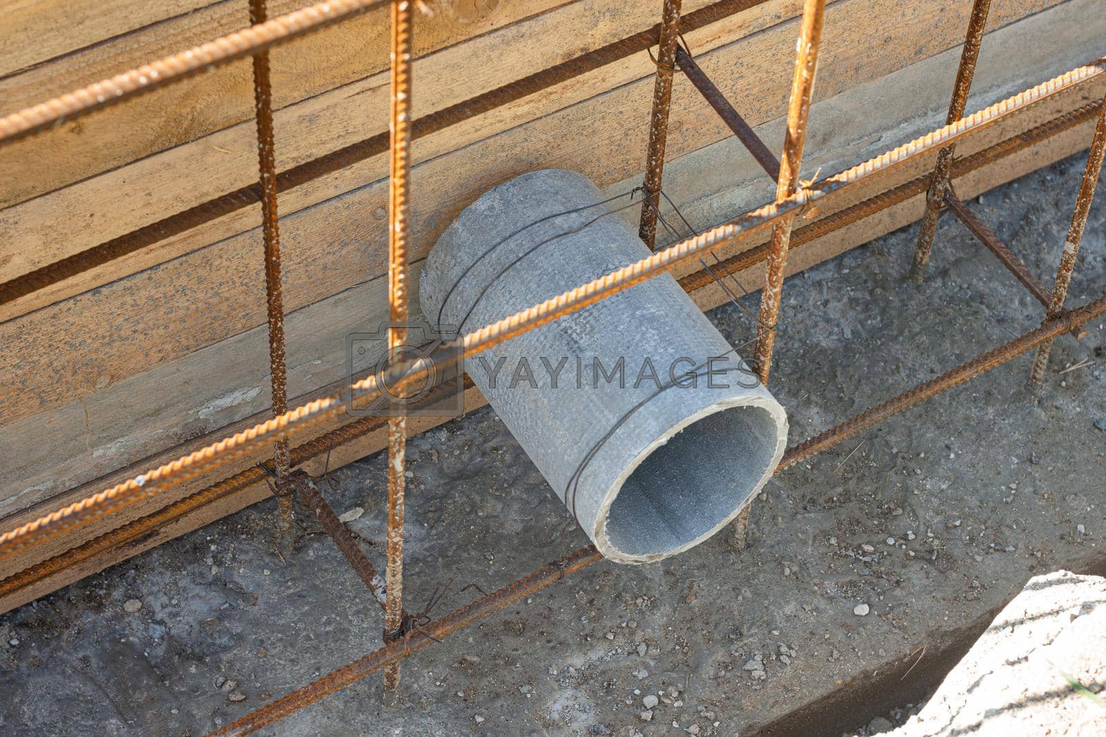 Royalty free image of Laying a sleeve for communications during the construction of a strip foundation by Madhourse