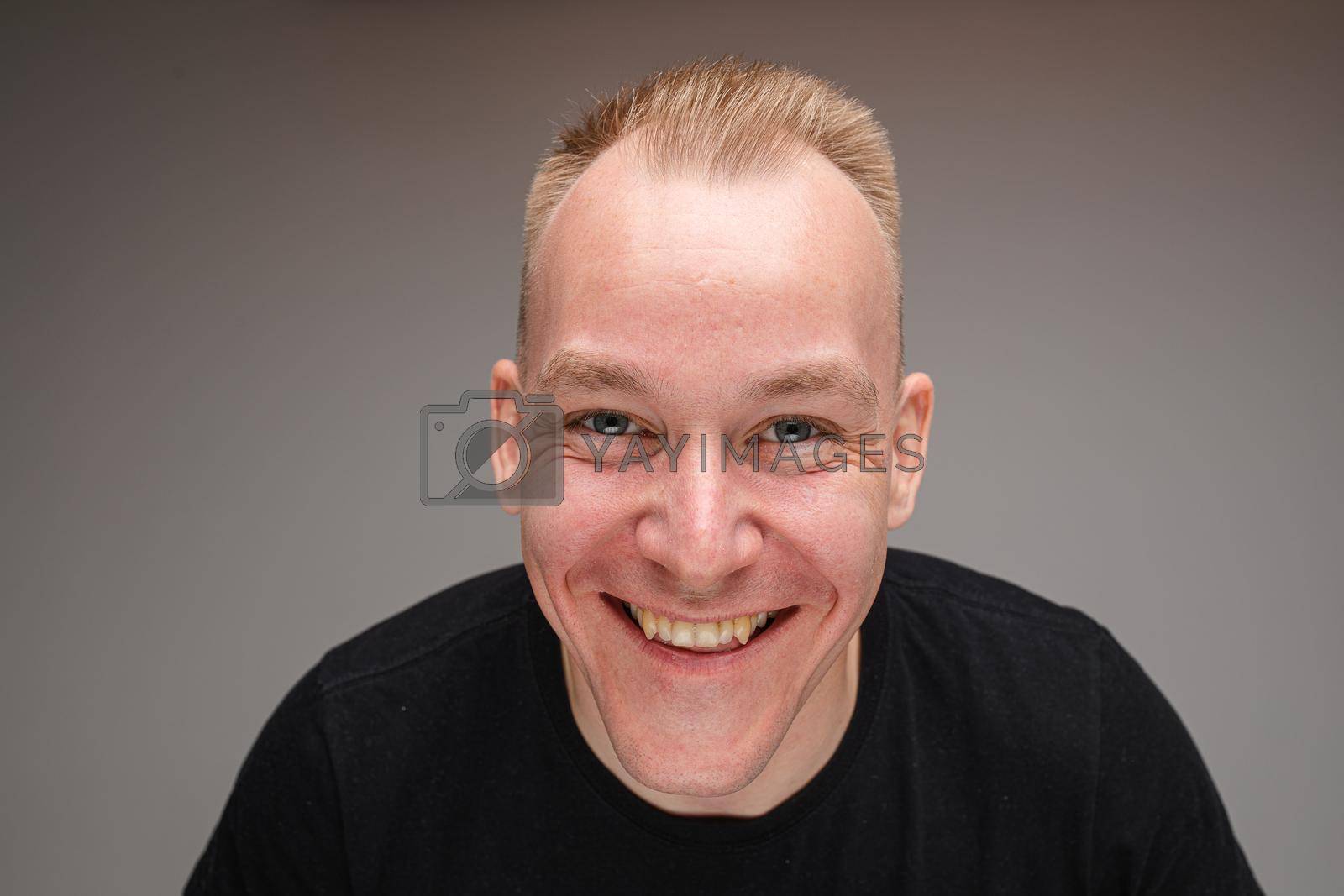 Royalty free image of Copy-space photo of cheerful young man with big smile by StudioLucky