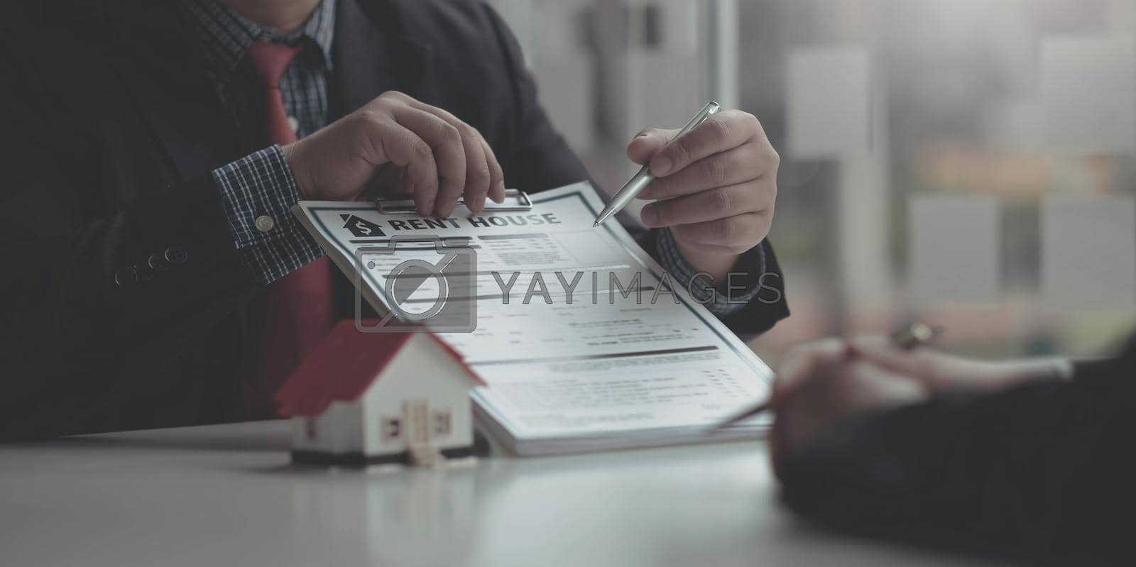 Royalty free image of Real Estate Agent broker or House developer showing contract for buying house agreement to consultant employee. by wichayada