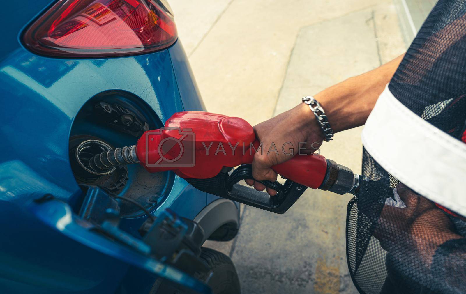 Royalty free image of Car fueling at gas station. Refuel fill up with petrol gasoline. Petrol pump filling fuel nozzle in fuel tank of car at gas station. Petrol industry and service. Petrol price and oil crisis concept. by Fahroni
