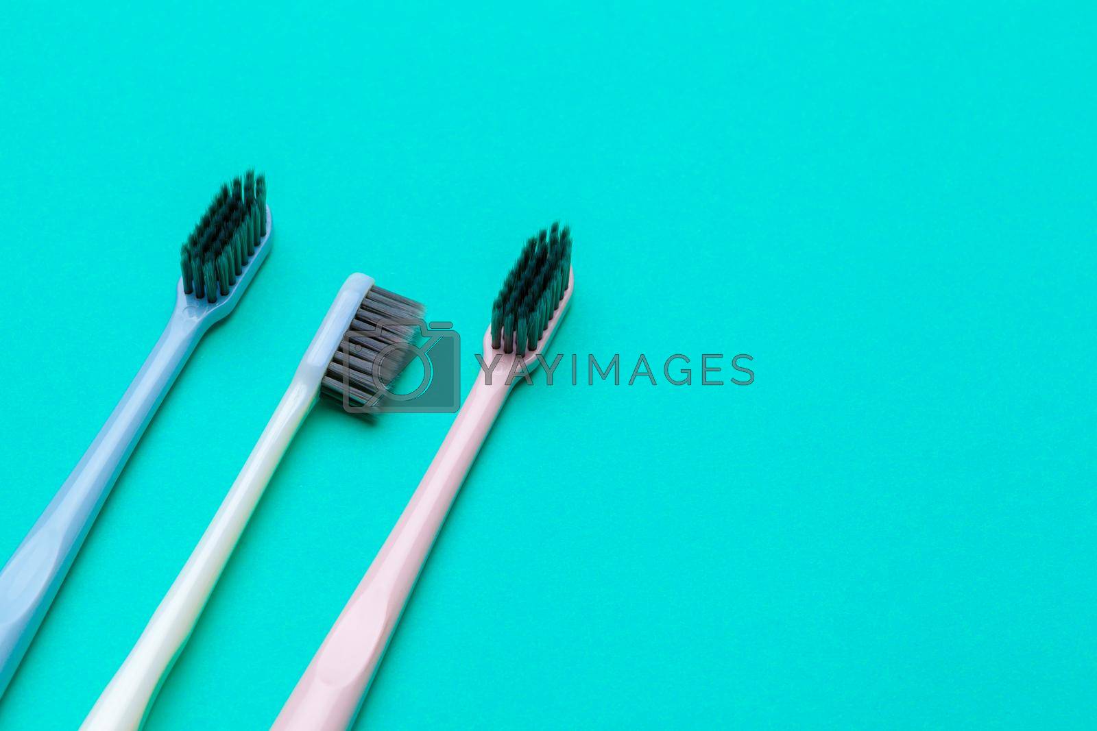 Royalty free image of Flat lay composition with manual toothbrushes on color background, close up by Fabrikasimf