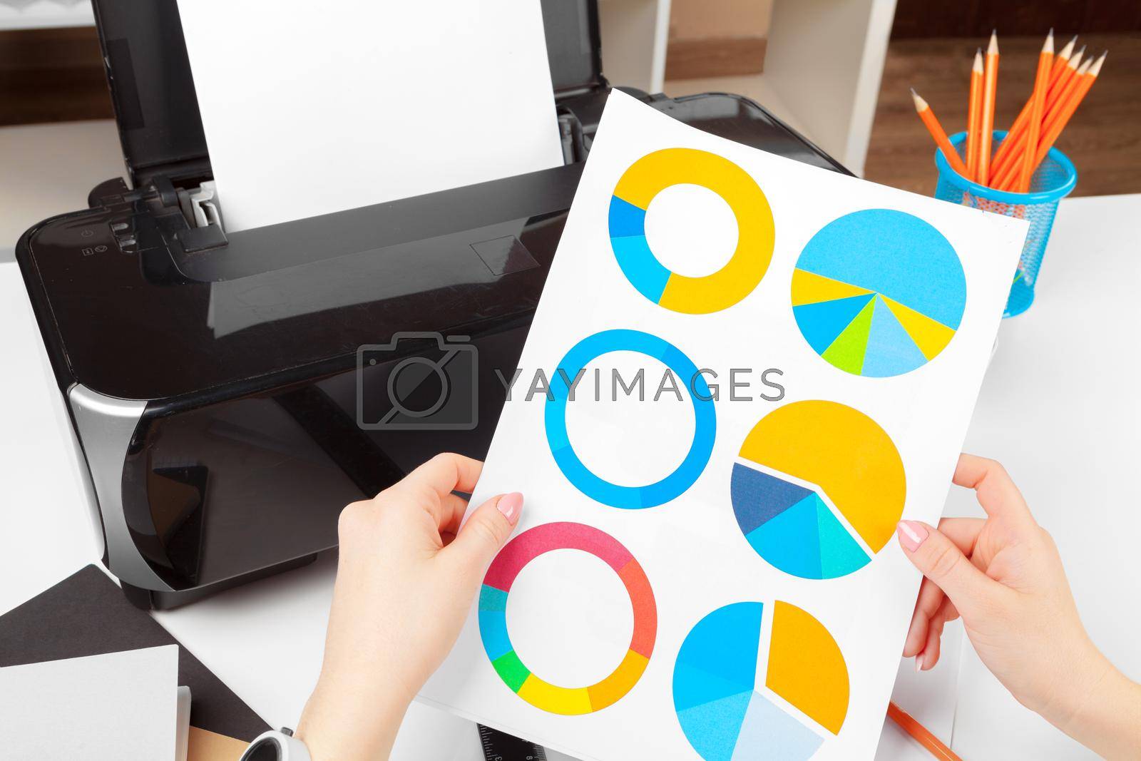 Royalty free image of Woman using the printer to scanning and printing document by Fabrikasimf