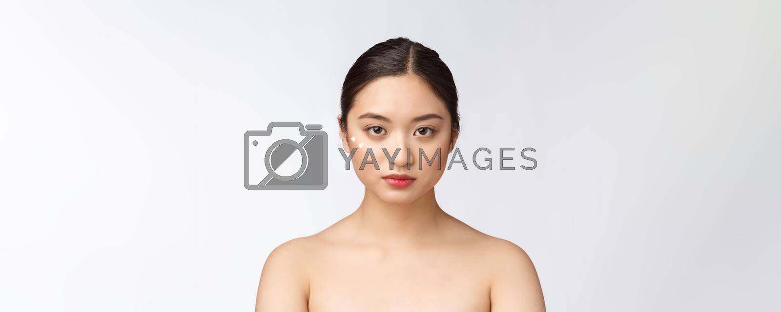 Skin care beauty woman. Beauty woman smiling applying cream. Beauty portrait of beautiful Asian Caucasian female model isolated on white