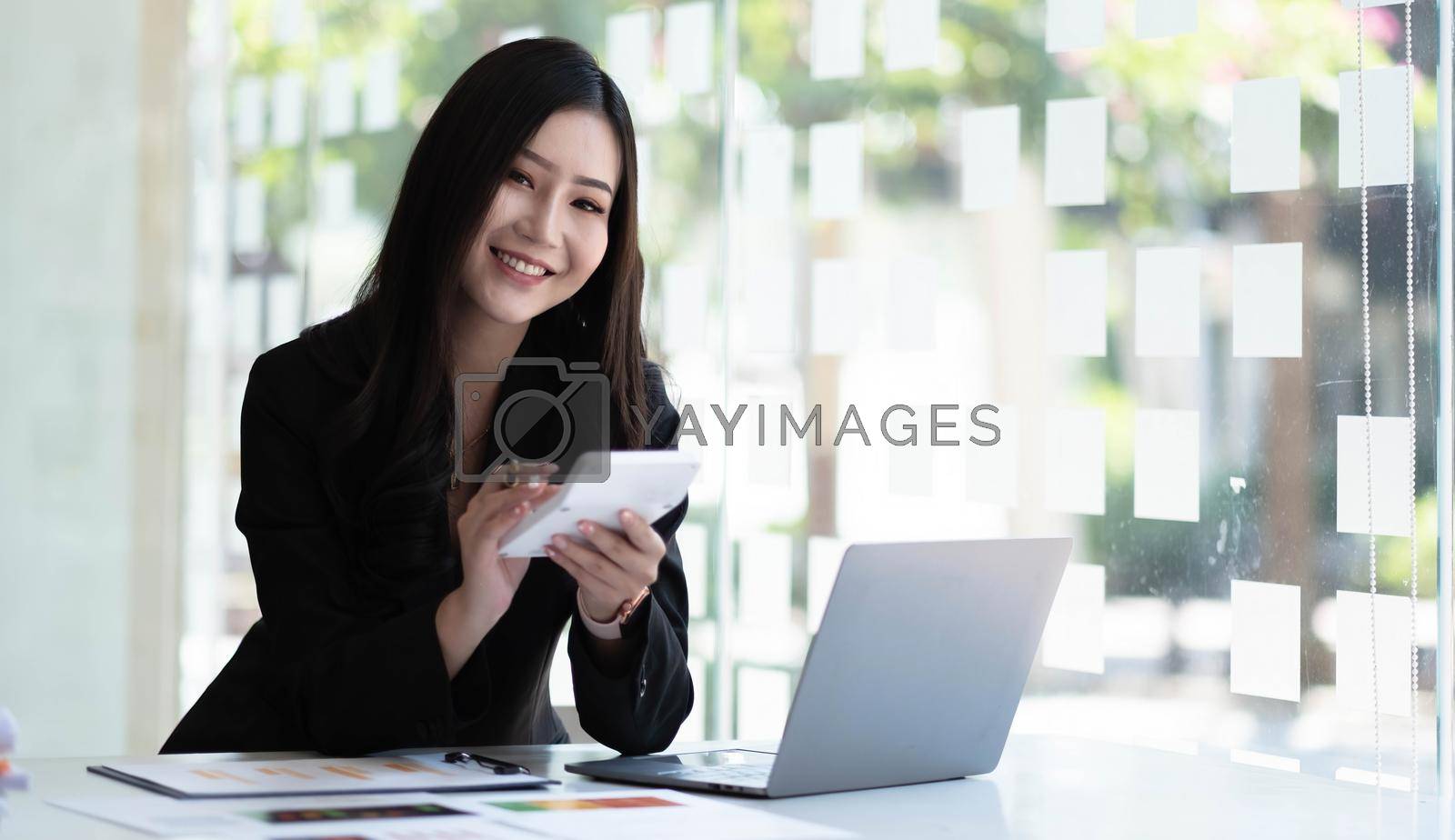 Businesswoman hands hold calculator with financial statistic stock photo,discussion and report analysis data the charts and graphs. Finance concept.