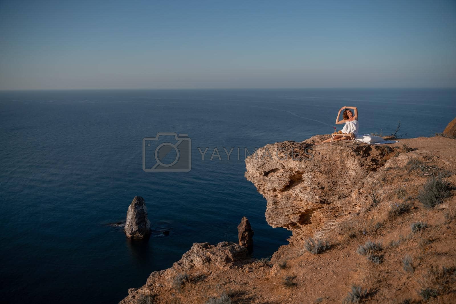 Royalty free image of Woman wake up in bed wuth duvet and pillow over nature sea background outdoors. Back view. Good morning. Freedom concept. by Matiunina