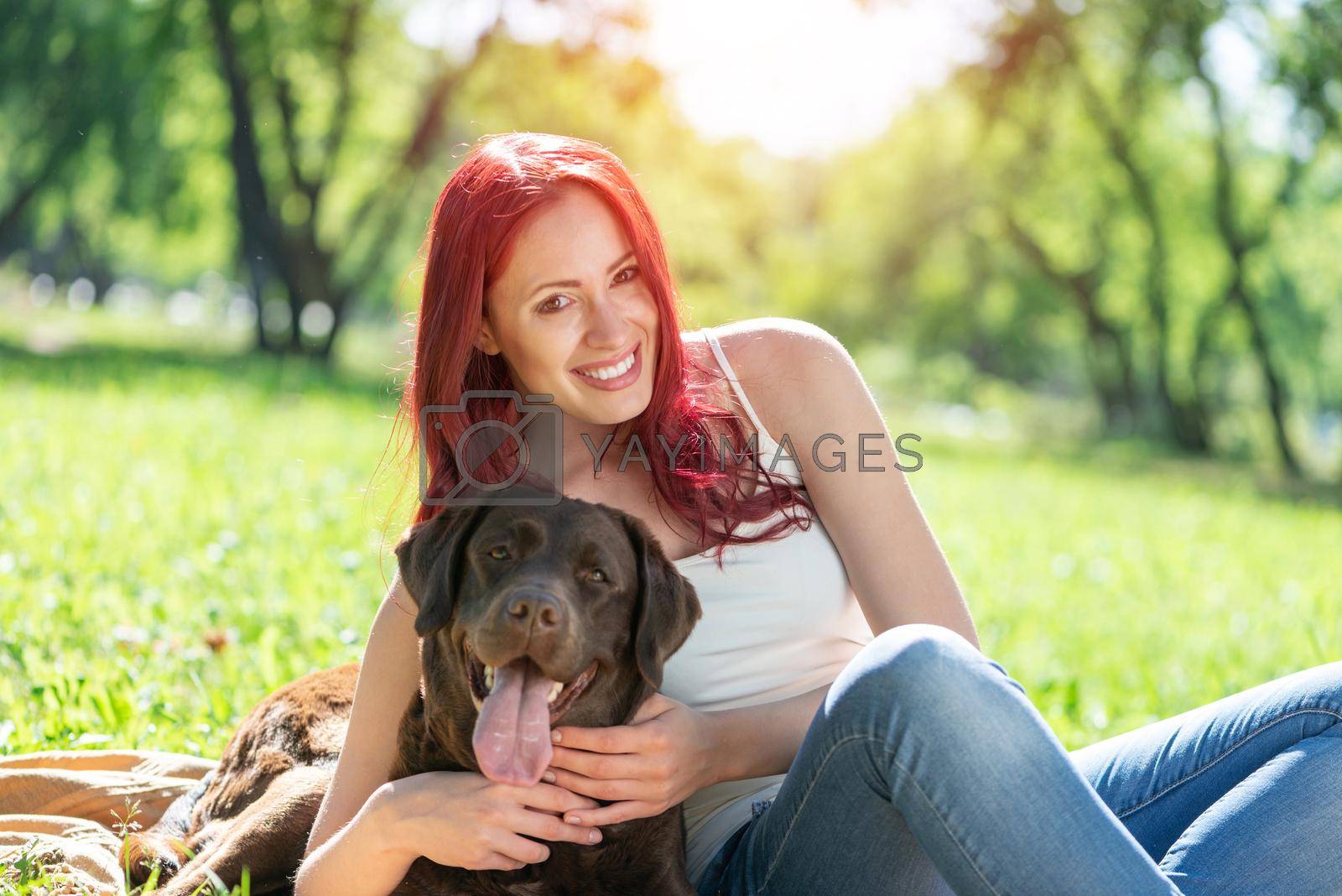 Woman in the park hugs a dog. Spend time with pets