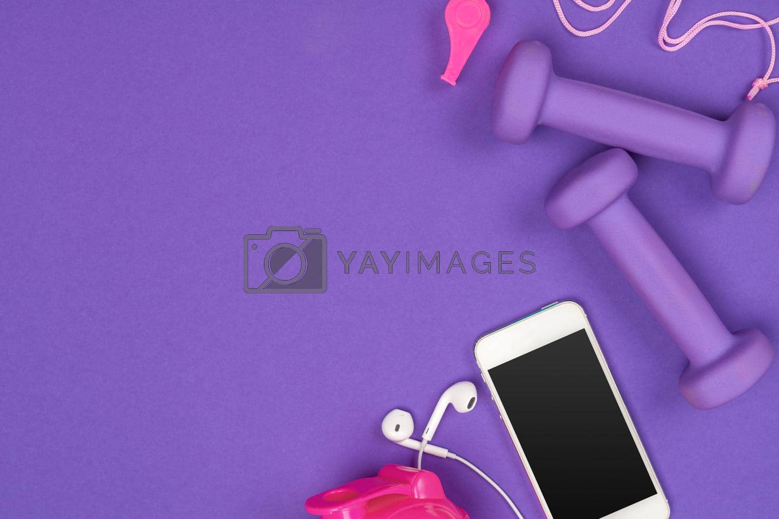 Fitness accessories on a color background.