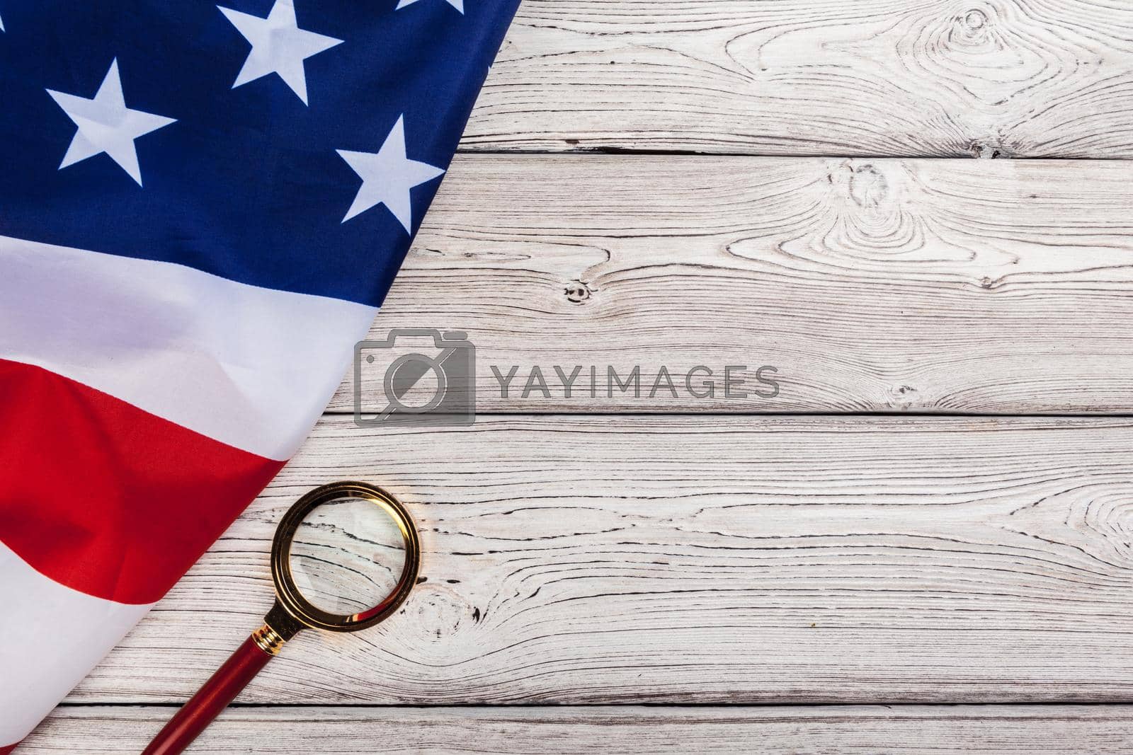 Royalty free image of Flag of USA and a magnifying glass by Fabrikasimf