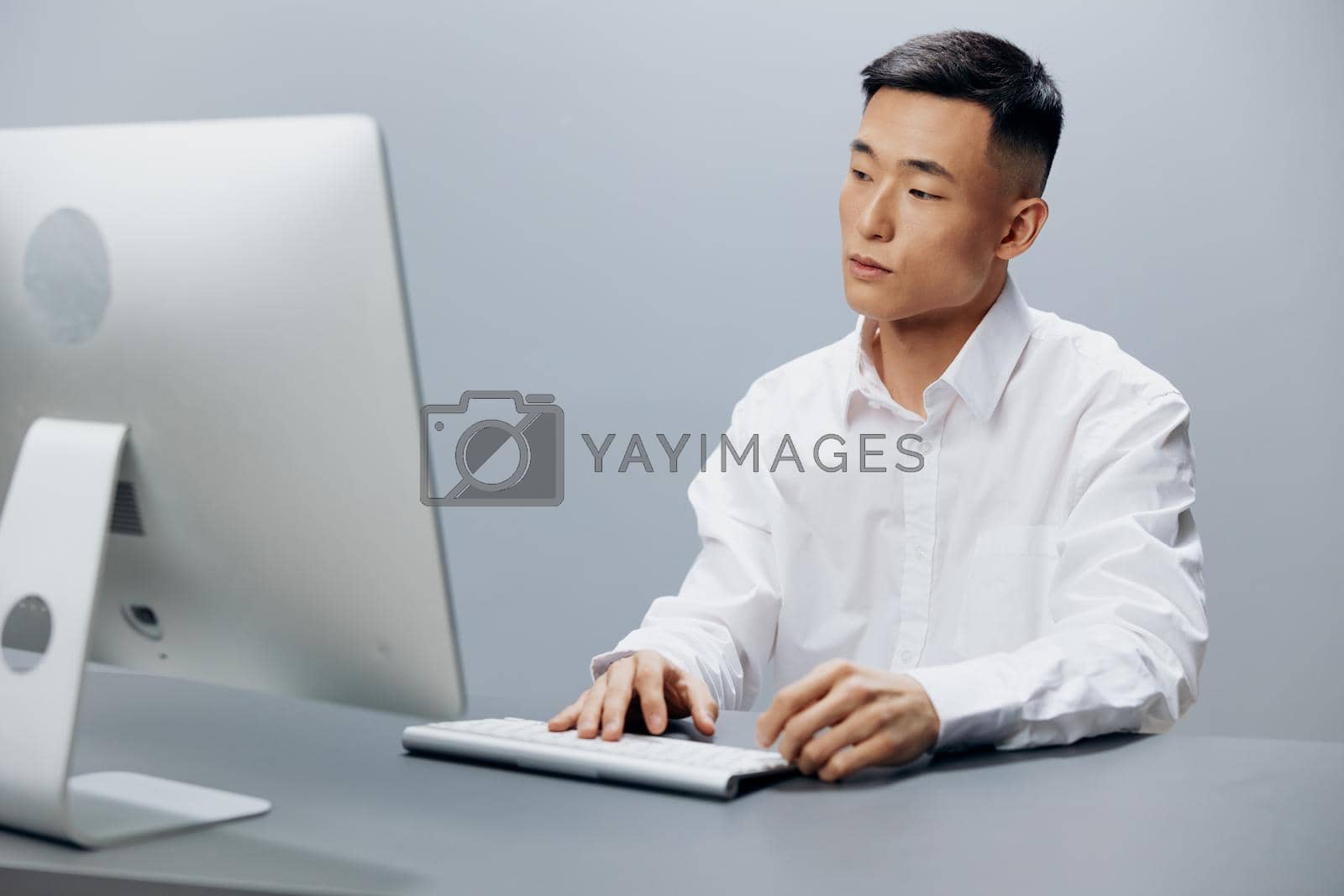 Royalty free image of manager sits at a computer in the office with a keyboard technologies by SHOTPRIME