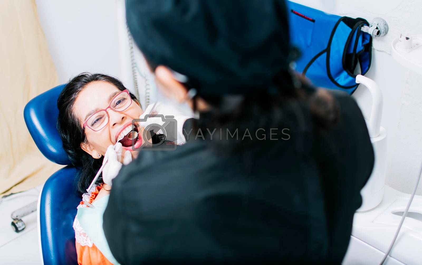 Top view of dentist doing dental checkup, patient checked by dentist, close up of dentist with patient, dentist doing root canal treatment on patient