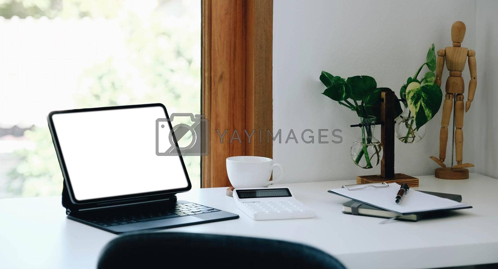 Royalty free image of Digital tablet with white blank screen on table. workspace in modern office concept.. by wichayada