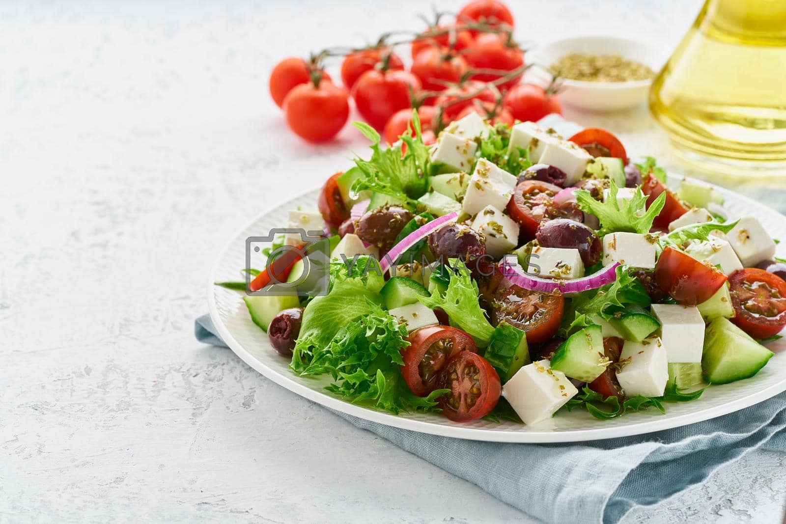 Royalty free image of Greek Salad with feta and tomatoes, dieting food on white background copy space closeup by NataBene