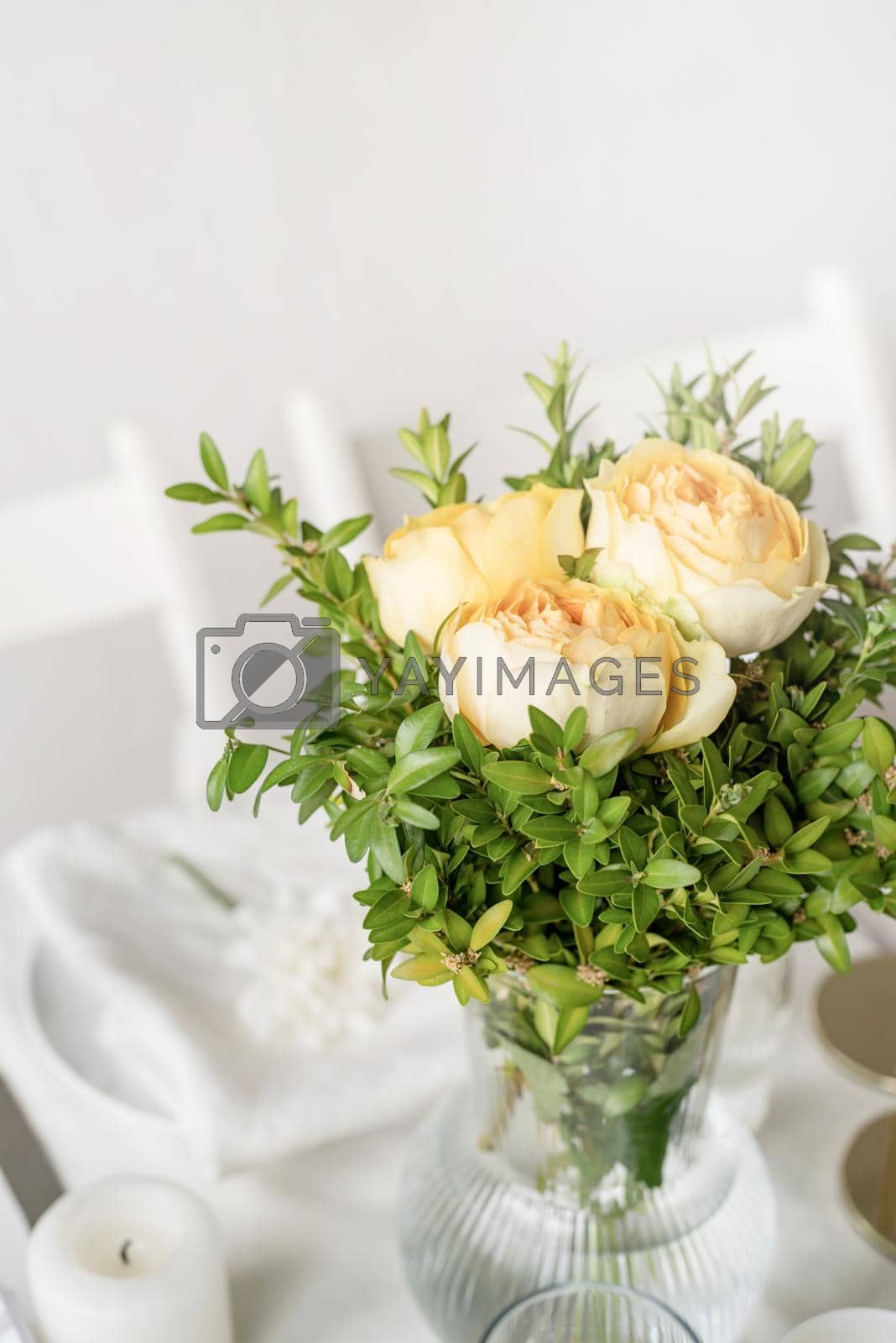 Royalty free image of The wedding decor. Wedding teble decoration with beige roses, closeup by Desperada