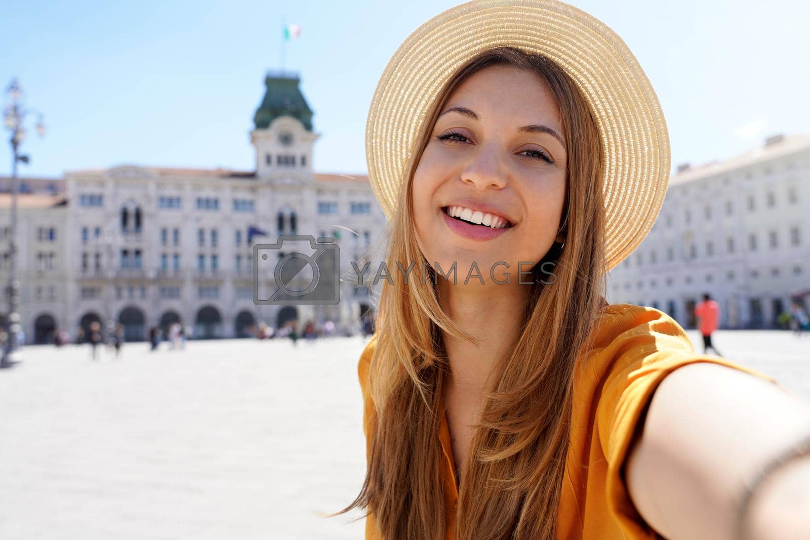 Royalty free image of Cultural tourism in Italy. Self portrait of smiling traveler girl visiting Trieste, Italy. by sergio_monti
