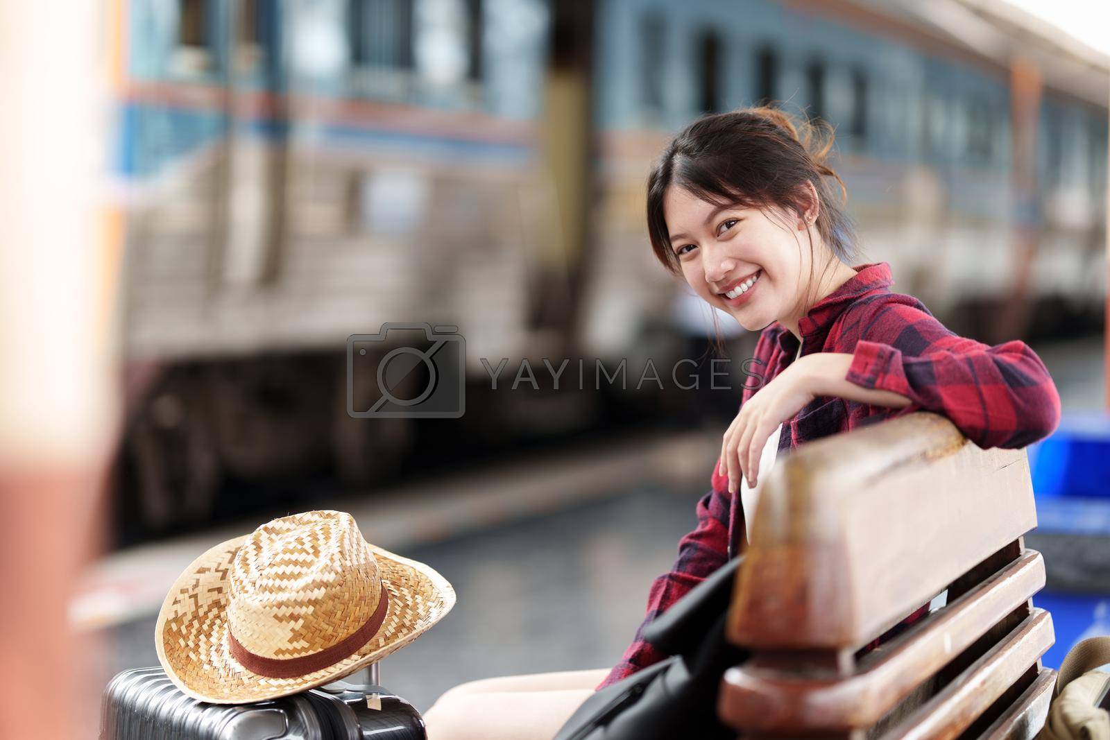 Pretty Young traveler woman planning trip at train station. Summer and travel lifestyle concept