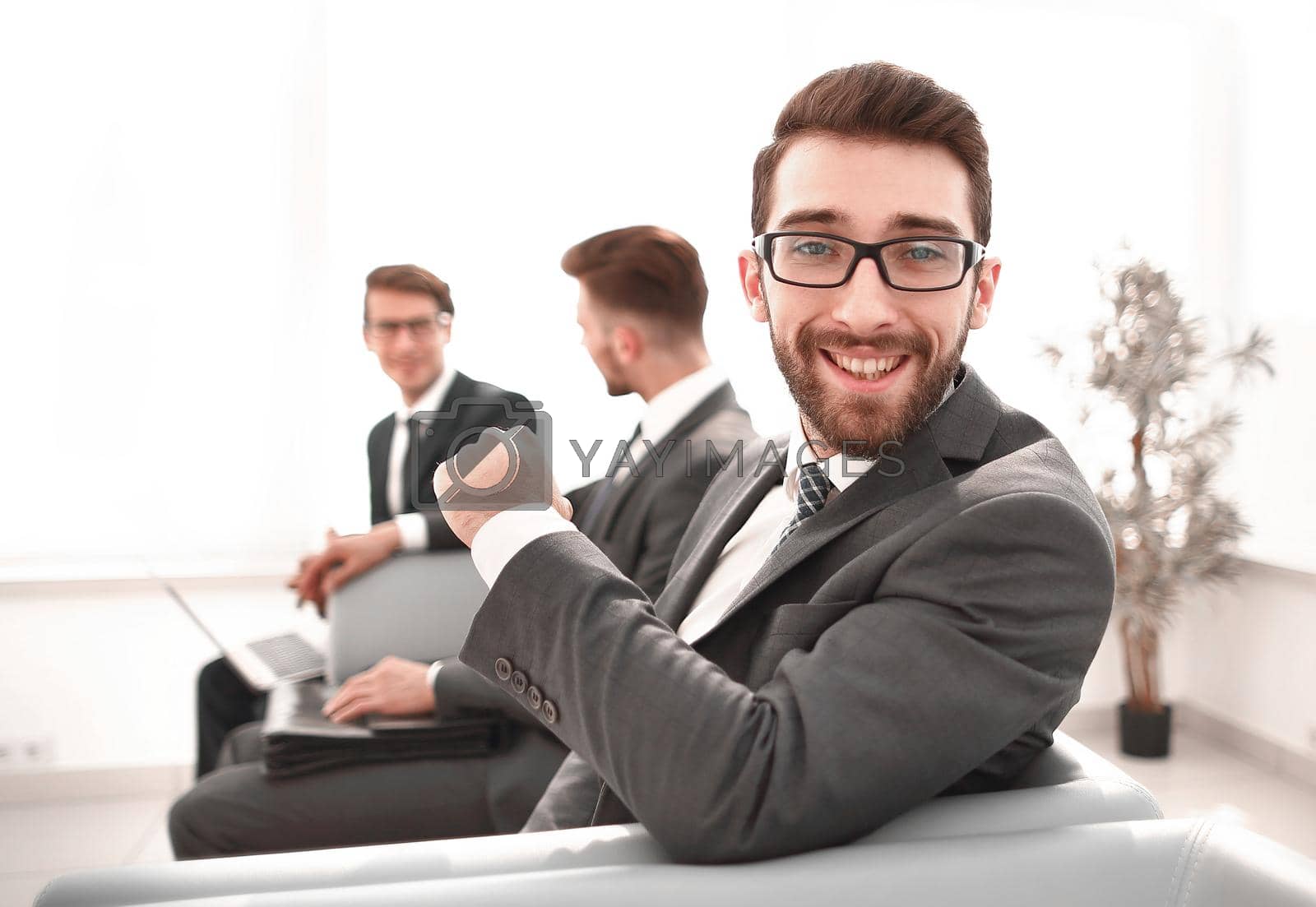Royalty free image of portrait of a successful businessman sitting in the lobby of the business center by asdf