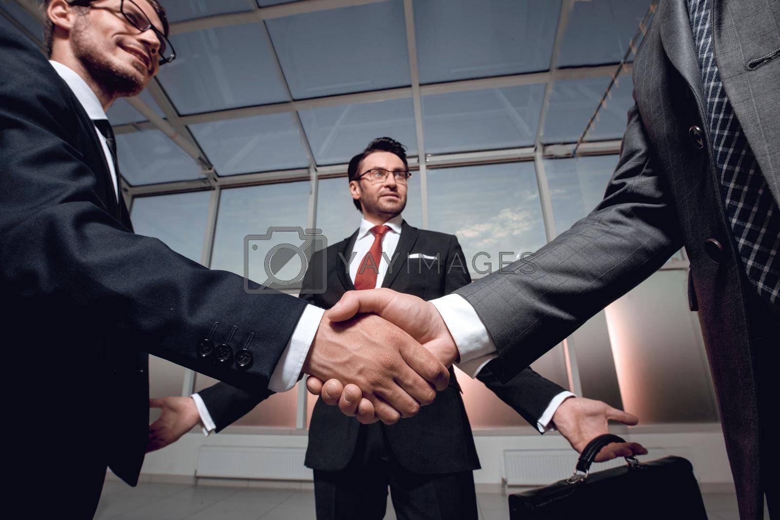 Royalty free image of business partners shake hands by asdf